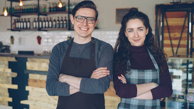 Happy restaurant staff smiling together